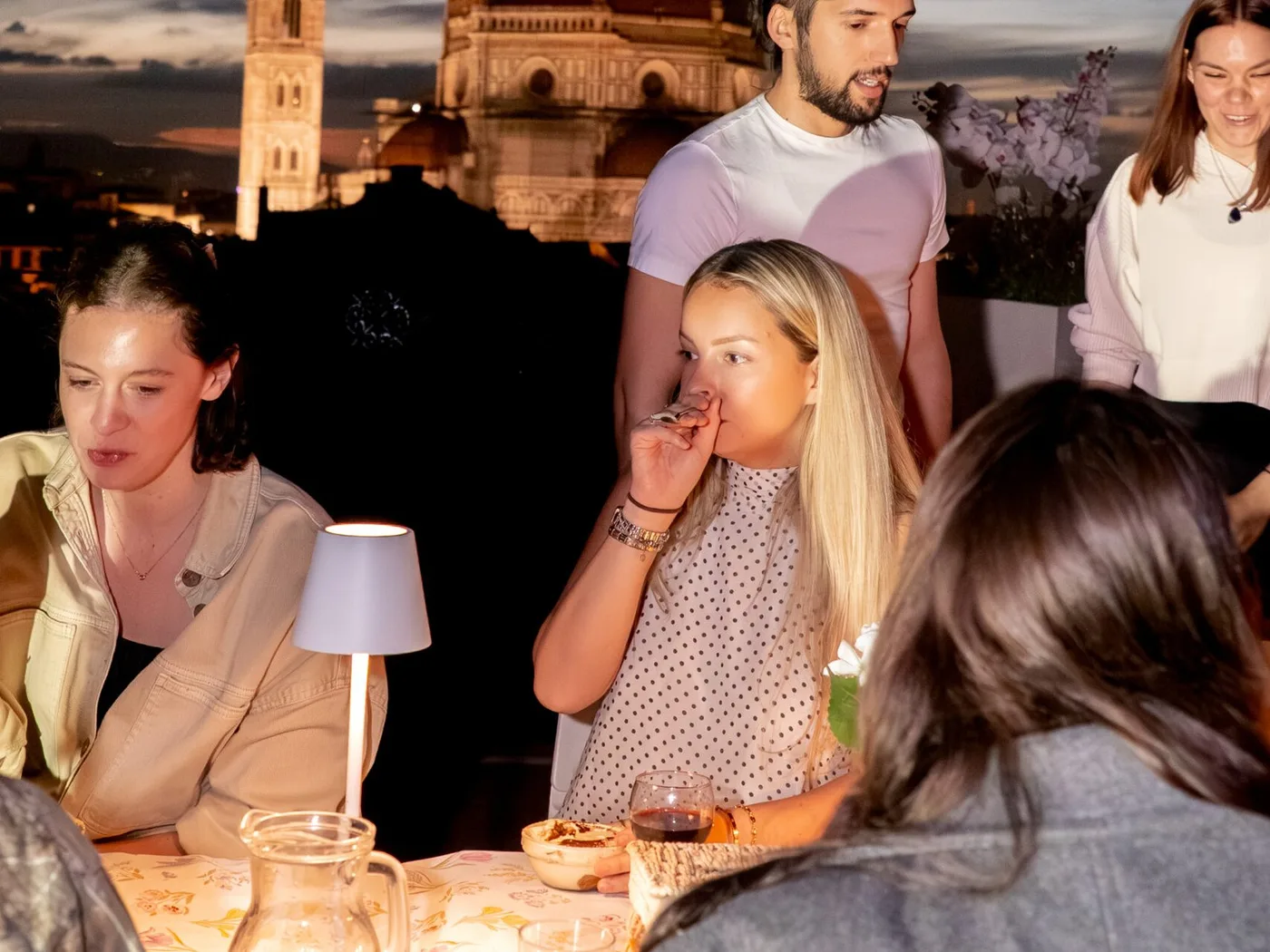 Guests dining together on the rooftop in the evening